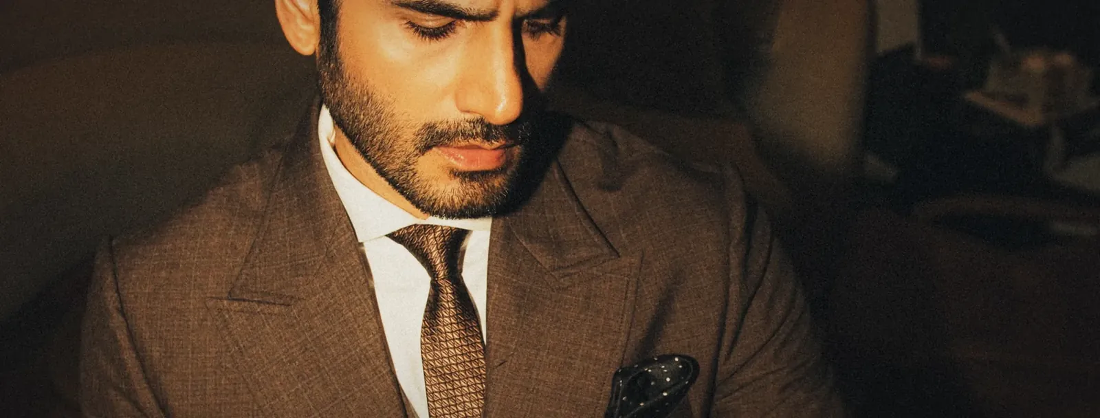 Karan Tacker · brown three-piece