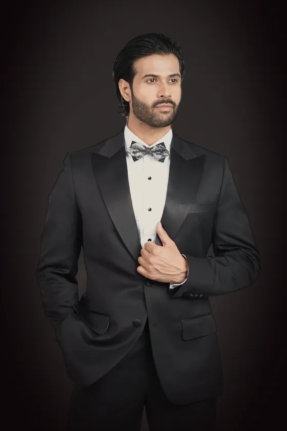 The black tuxedo with a peak lapel, worn with a bow tie