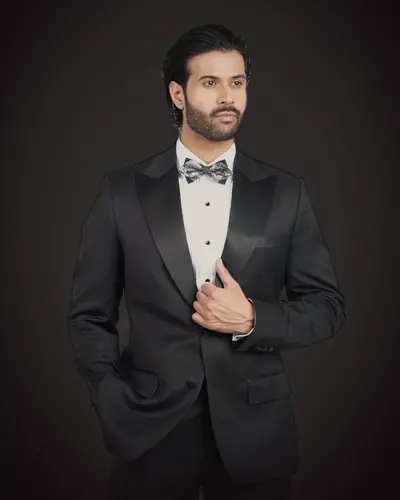 The black tuxedo, worn