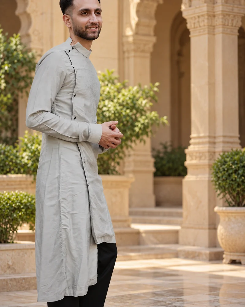 Worn: The same kurta, open at the step · band collar, in dove grey.
