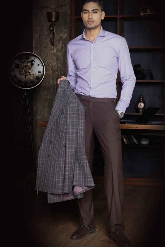 The lilac cutaway-collar shirt, worn with brown trousers, a windowpane jacket in hand
