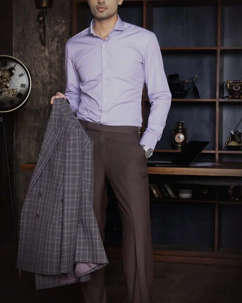 Worn: The same shirt, at the desk · with brown trousers.