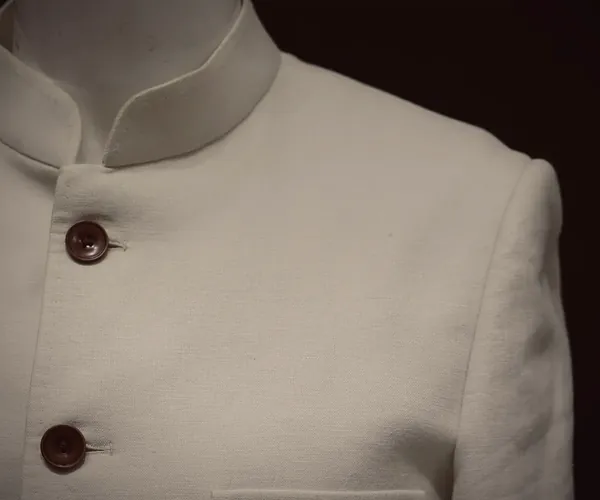 Captain Jodhpuri: Band collar and pleated chest pocket · in off-white linen.