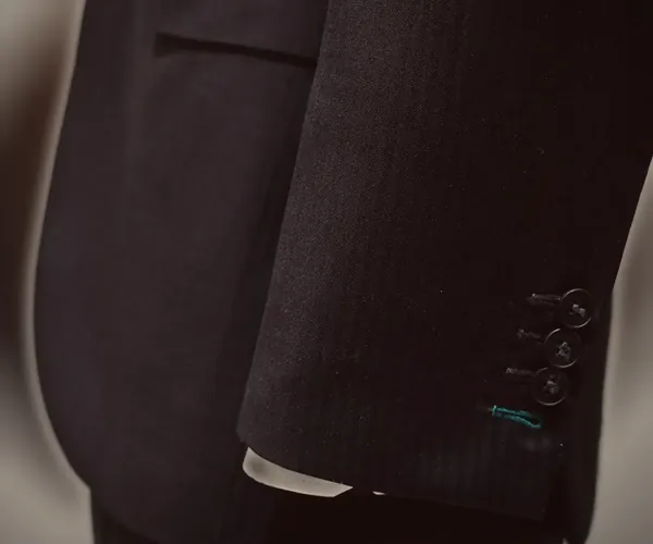 Classic Suit: Working cuff buttons · flap pocket at the hip.