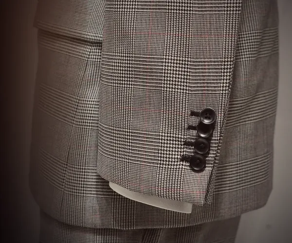 Prince Charles Suit: Four buttons at the cuff · flap pocket at the hip.