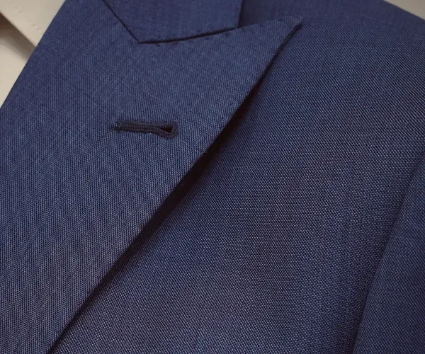 Swanky Suit: Peak lapel and chest pocket · in medium blue.
